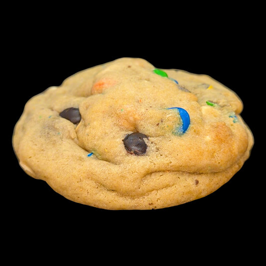 Cookie with chocolate chips and colorful candies on a black background
